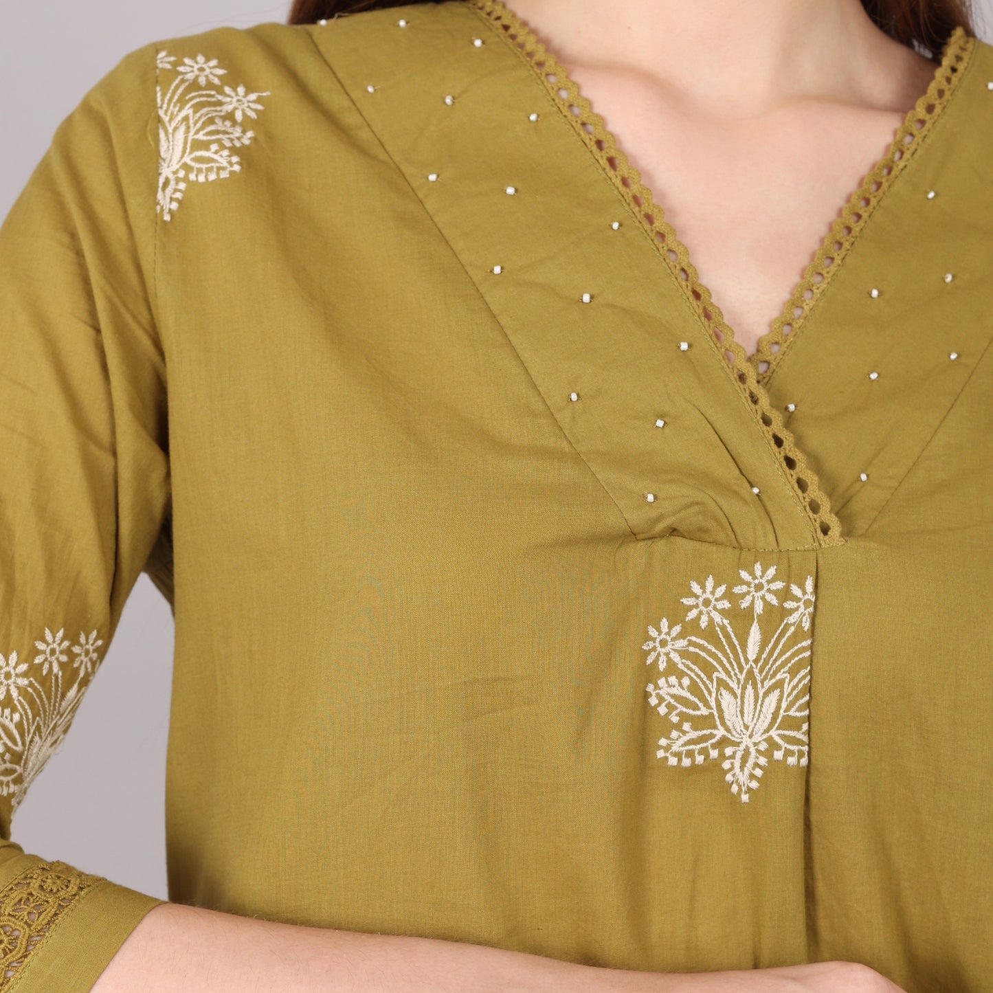 Stylish floral embroidered pure cotton kurta set with intricate pleats, beads, and stone embellishments for a festive touch.