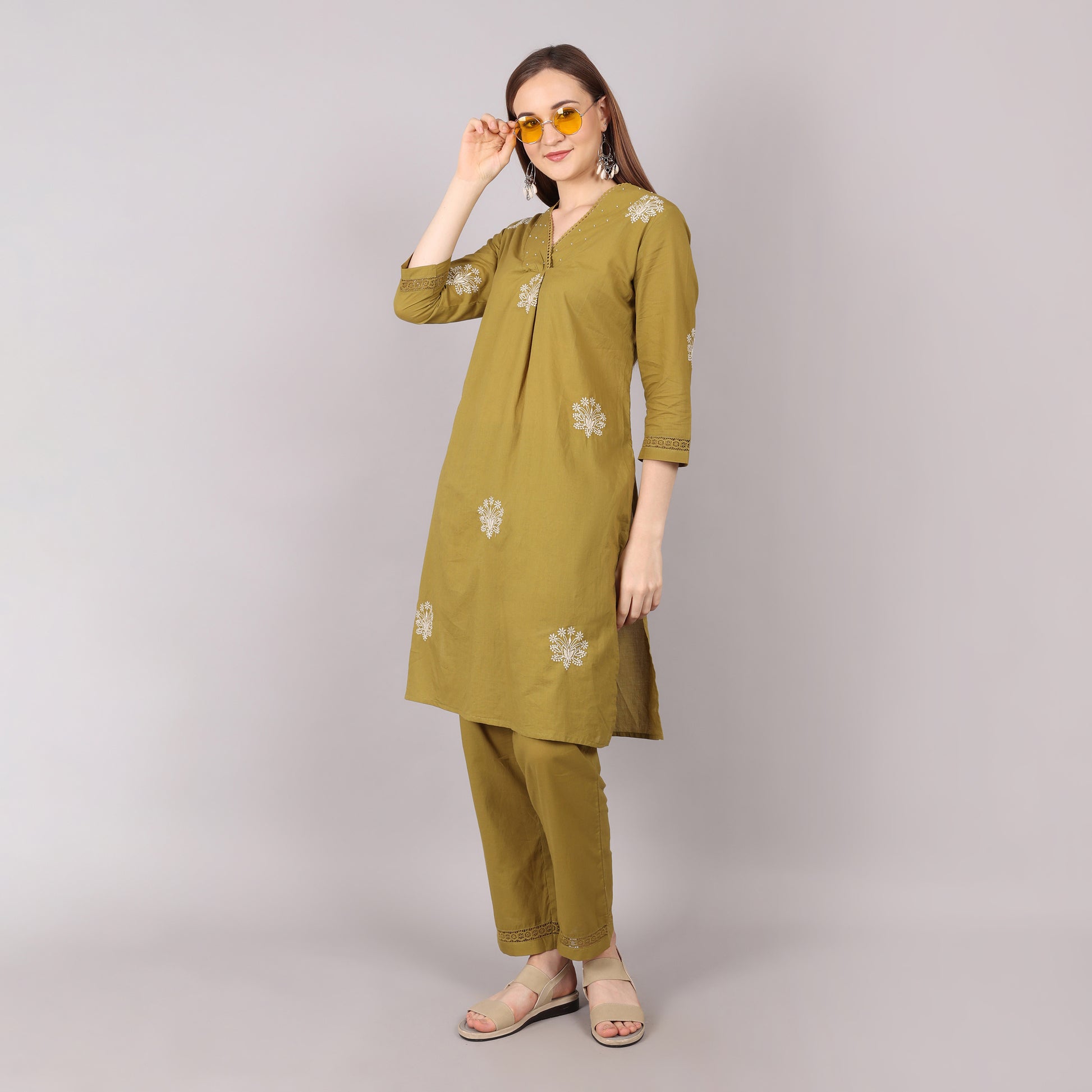 Elegant pure cotton kurta set featuring floral embroidery with pleated details, adorned with beads and stones for a sophisticated look.