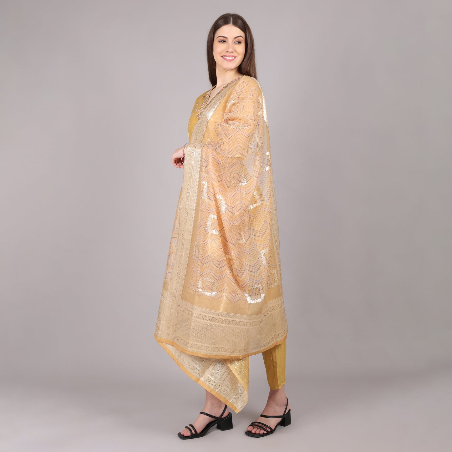 Elegant golden pure tissue kurta set featuring a luxurious sheen for a regal look.