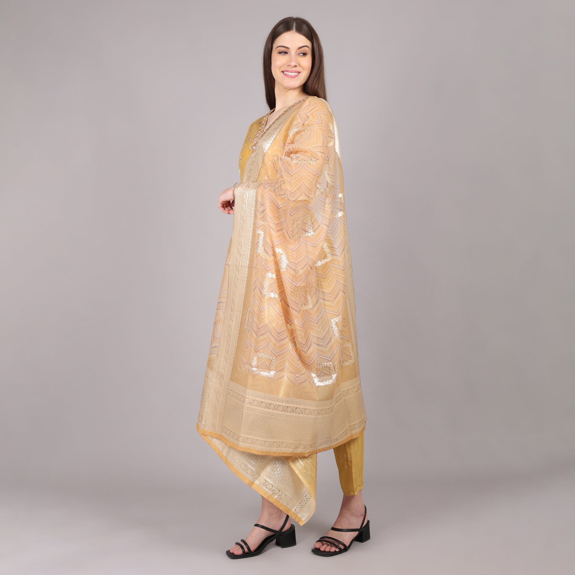 Elegant golden pure tissue kurta set featuring a luxurious sheen for a regal look.