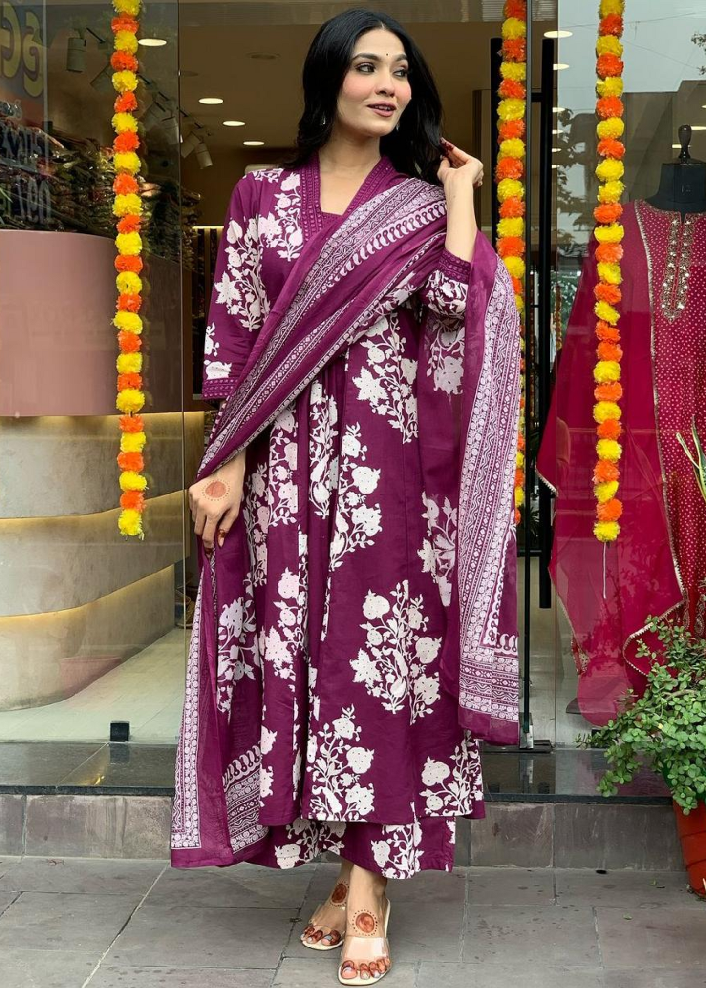 Vibrant and elegant floral printed A-line kurta set in magenta and white, complete with a pleated neckline, comfortable palazzos, and a soft dupatta.