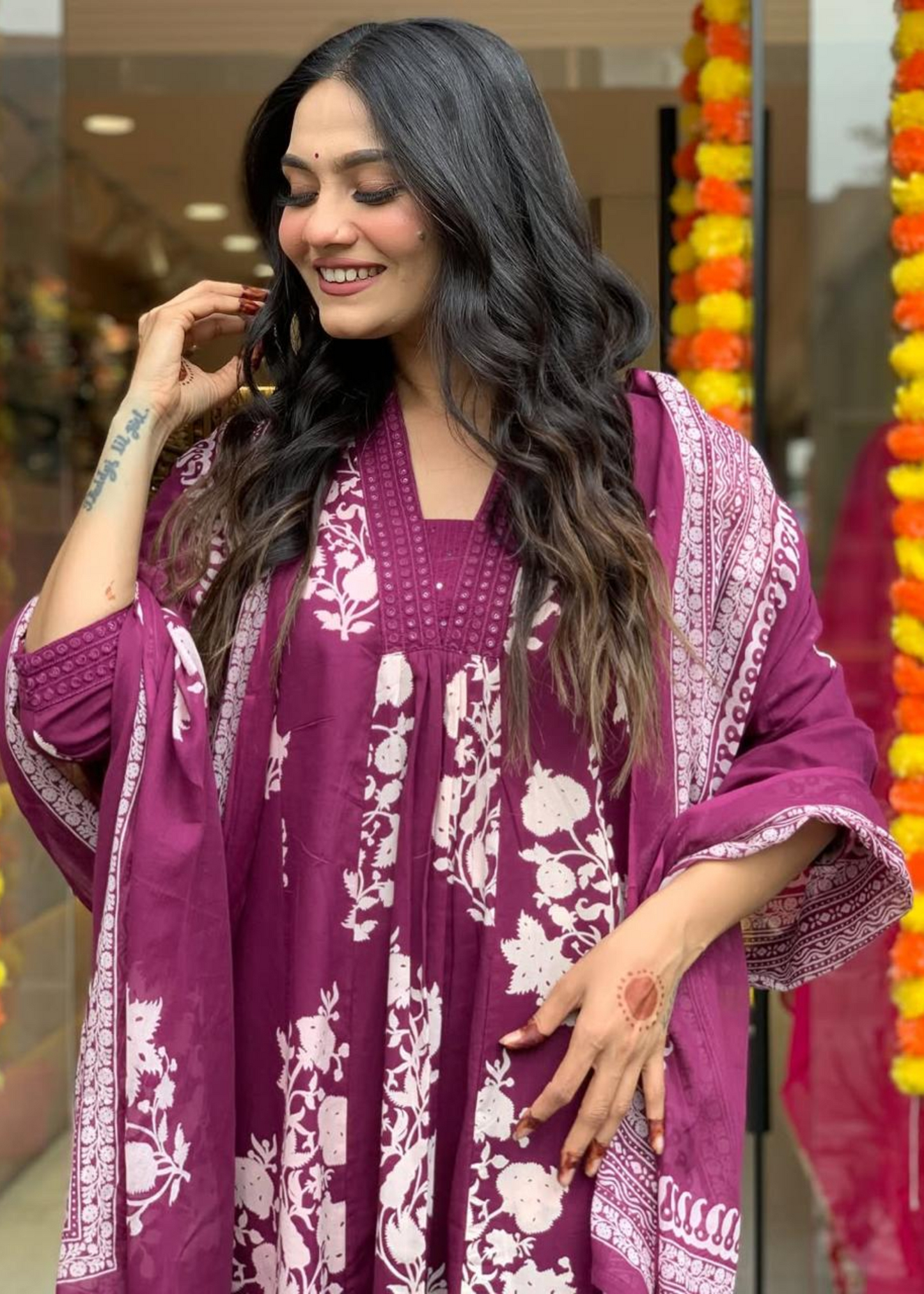 Sophisticated magenta and white floral printed ensemble featuring a pleated V-neck kurta, stylish palazzos, and a lightweight dupatta.