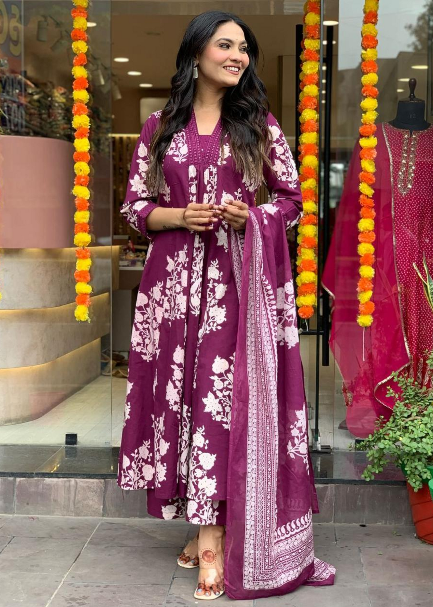 Chic and comfortable floral printed A-line kurta in magenta and white, designed with pleated details and a matching palazzo-dupatta set.
