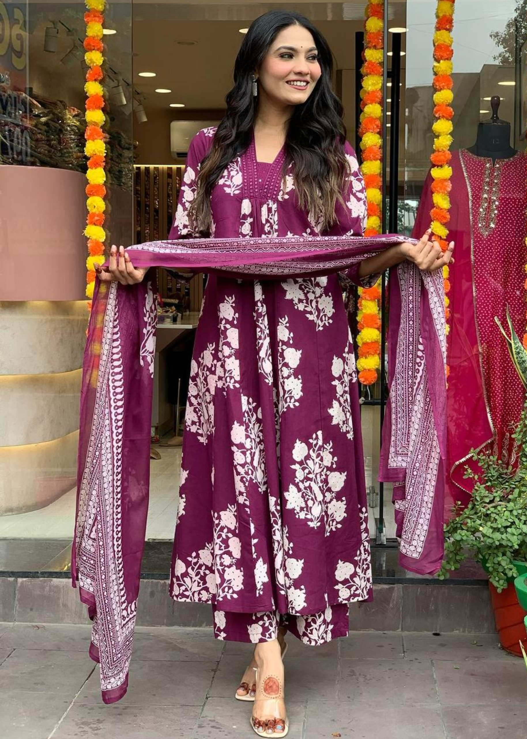 Elegant magenta and white floral printed A-line kurta with a pleated V-neck, paired with matching palazzos and dupatta.