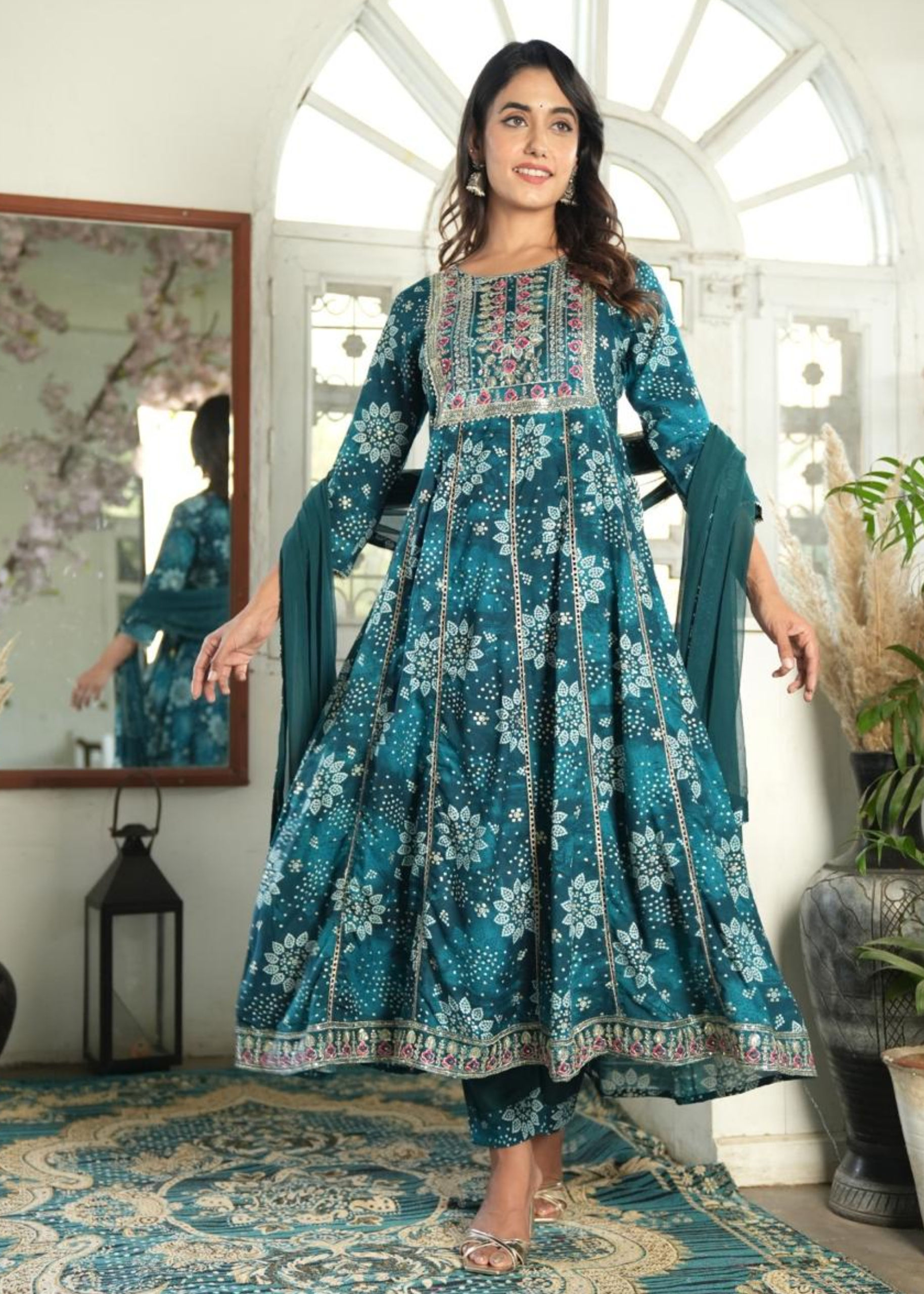 Graceful Anarkali kurti featuring vibrant Bandhni prints, complemented by stylish pants and a flowing dupatta.