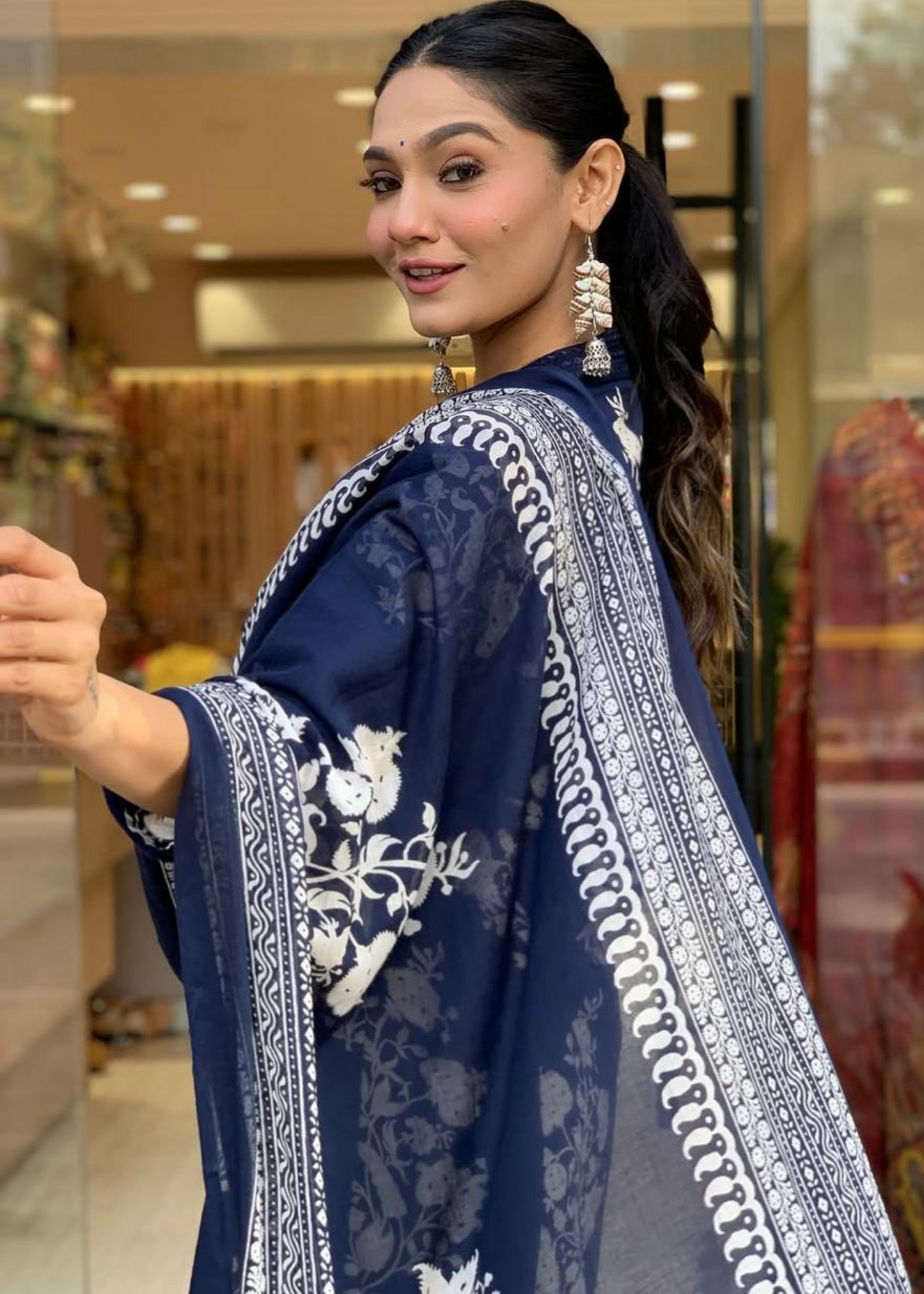 Lightweight and fashionable pleated V-neck A-line kurta set with floral prints, paired with palazzos and a flowing dupatta.