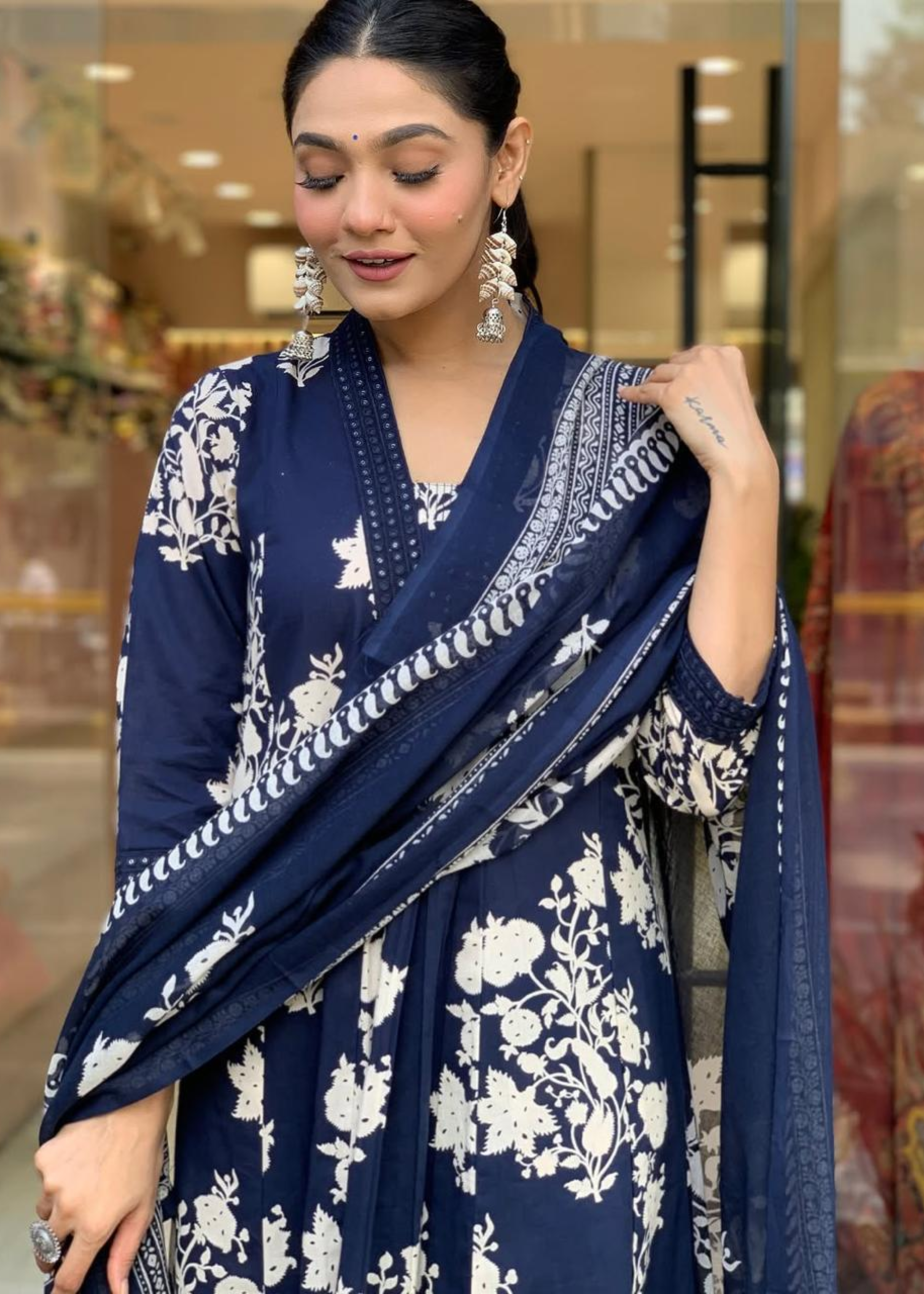 Stylish floral printed kurta set in navy and white, featuring a pleated V-neck A-line silhouette with complementing palazzos and dupatta.