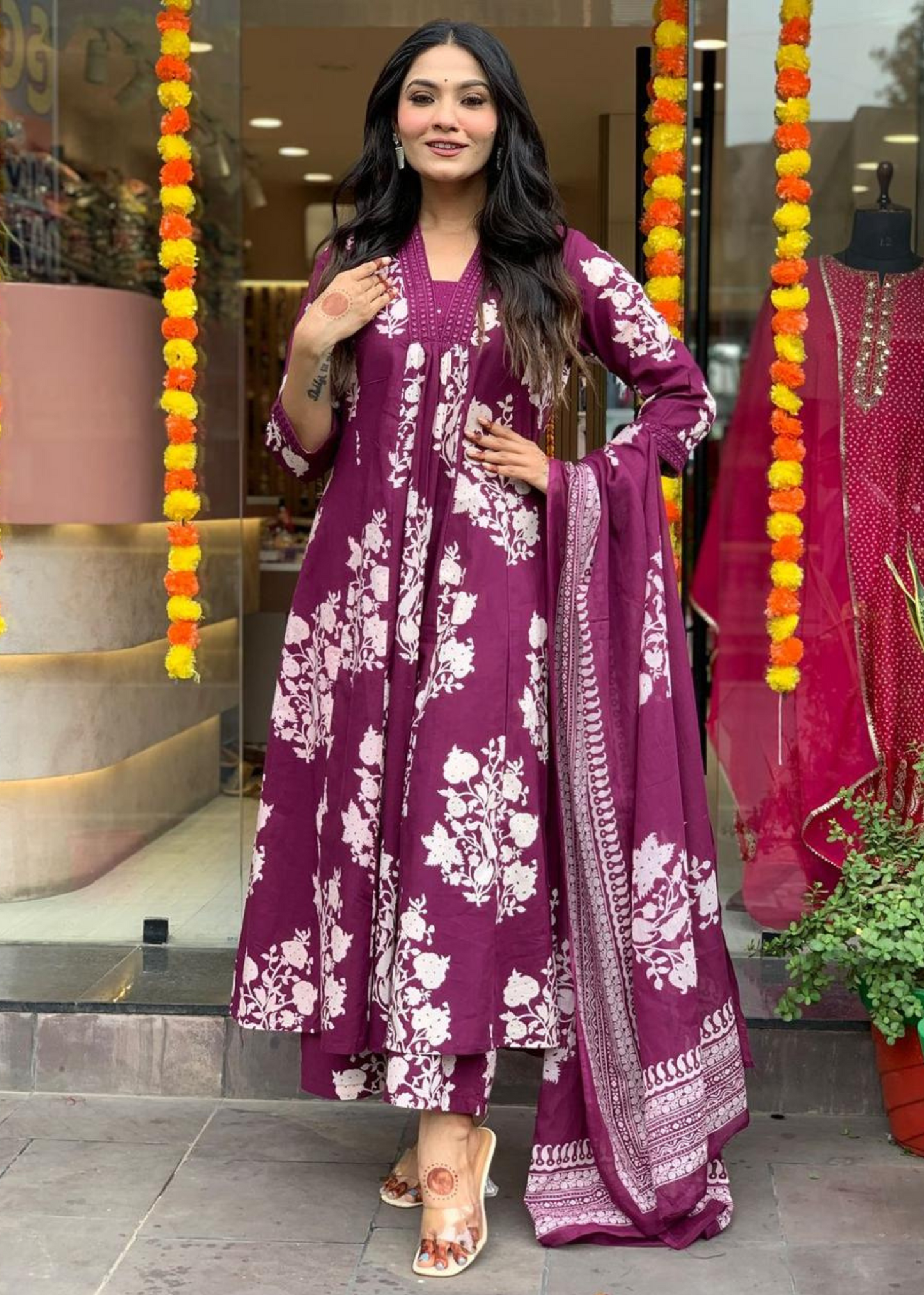 Chic and comfortable pleated V-neck A-line kurta set in magenta and white, featuring a graceful floral print with coordinated palazzos and dupatta.