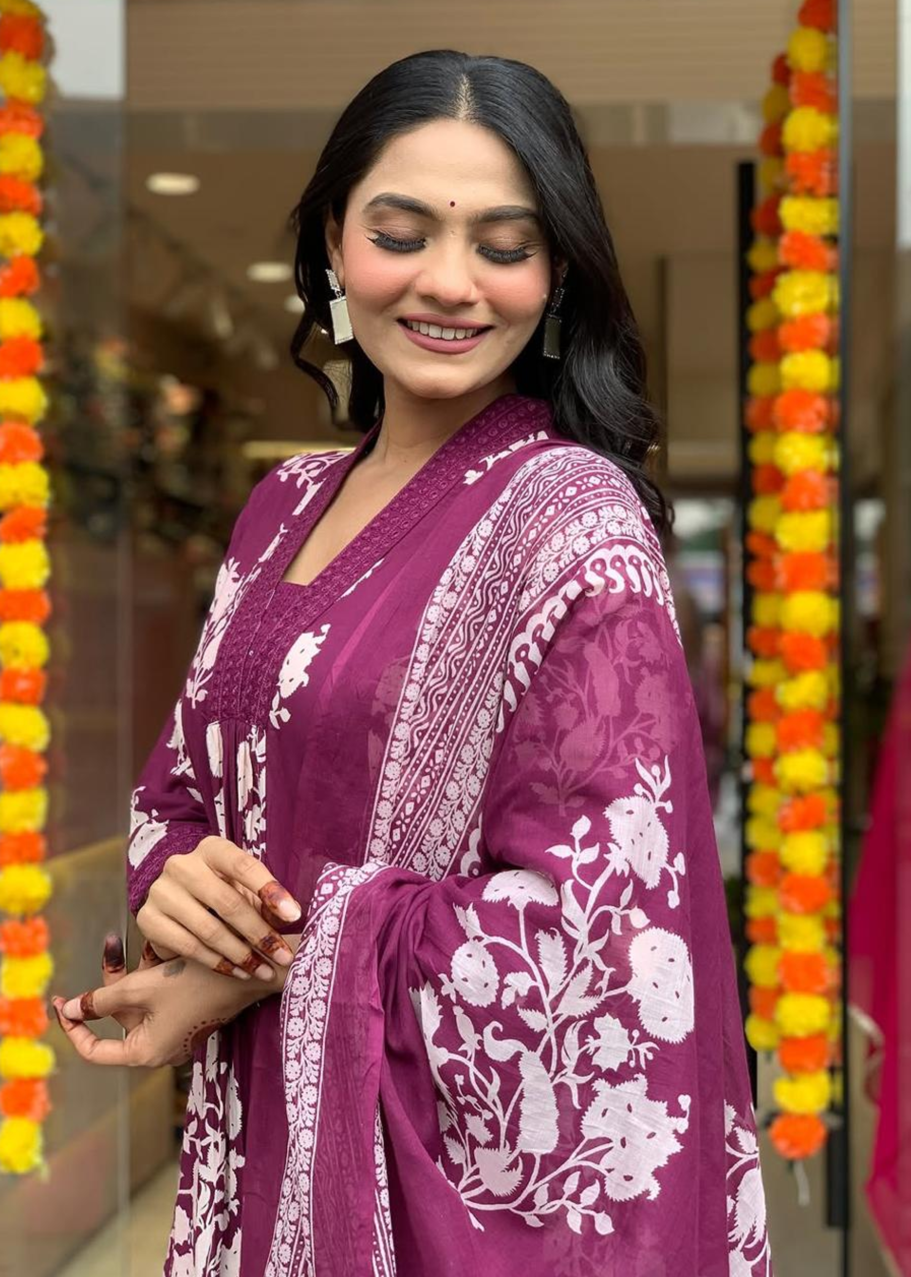 Elegant magenta and white floral printed A-line kurta with a pleated V-neck, paired with matching palazzos and a flowing dupatta.
