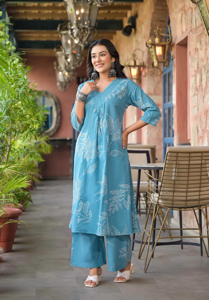 Graceful Rama blue A-line kurta set adorned with artistic floral prints and shimmering bead details for a refined finish.