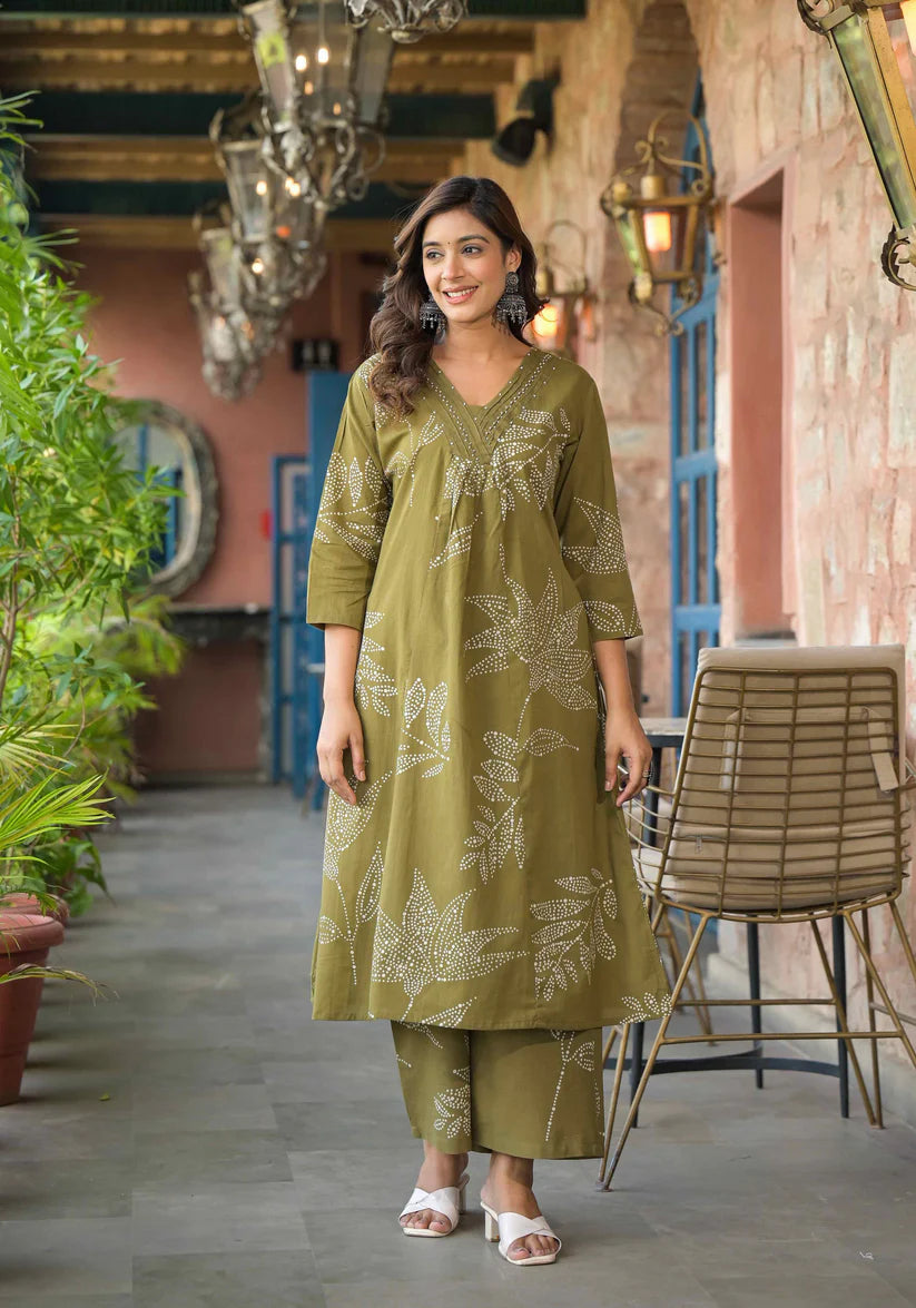 Graceful A-line kurta set in mehendi green with artistic floral prints and shimmering beadwork, perfect for festive occasions.