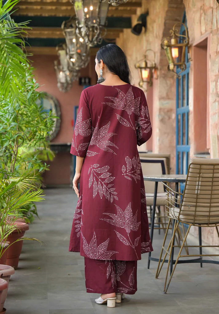 Elegant Mehroon A-line kurta set with abstract floral prints and intricate beadwork, perfect for a sophisticated ethnic look.