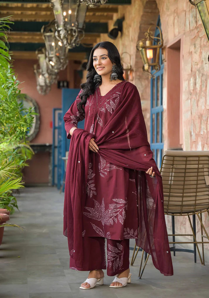 Graceful Mehroon A-line kurta set with artistic floral prints and shimmering bead details, ideal for special occasions.