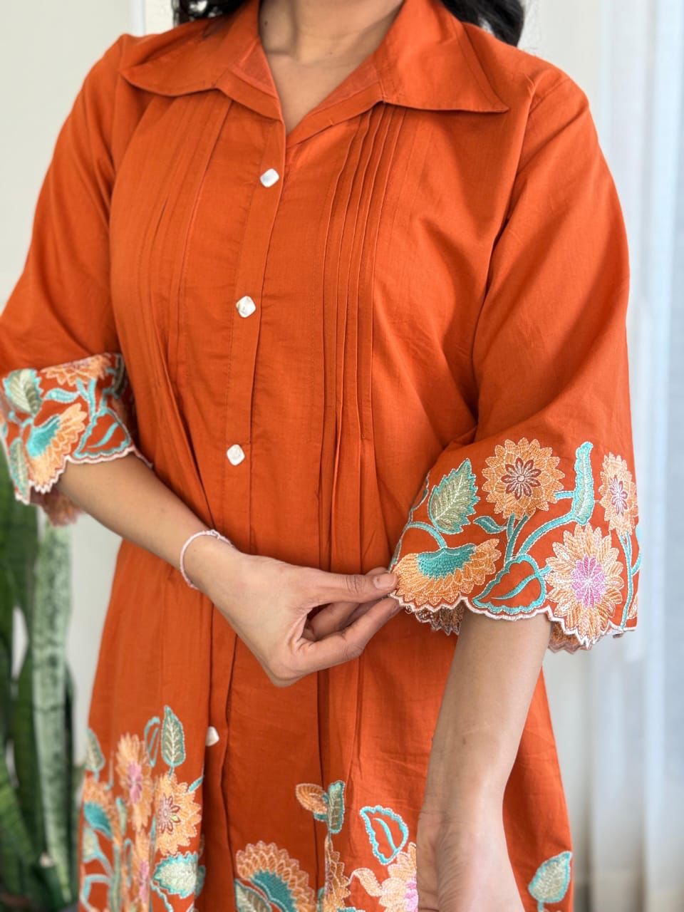 Stylish orange cotton co-ord set with beautiful embroidery and sequin work, blending elegance with modern fashion.