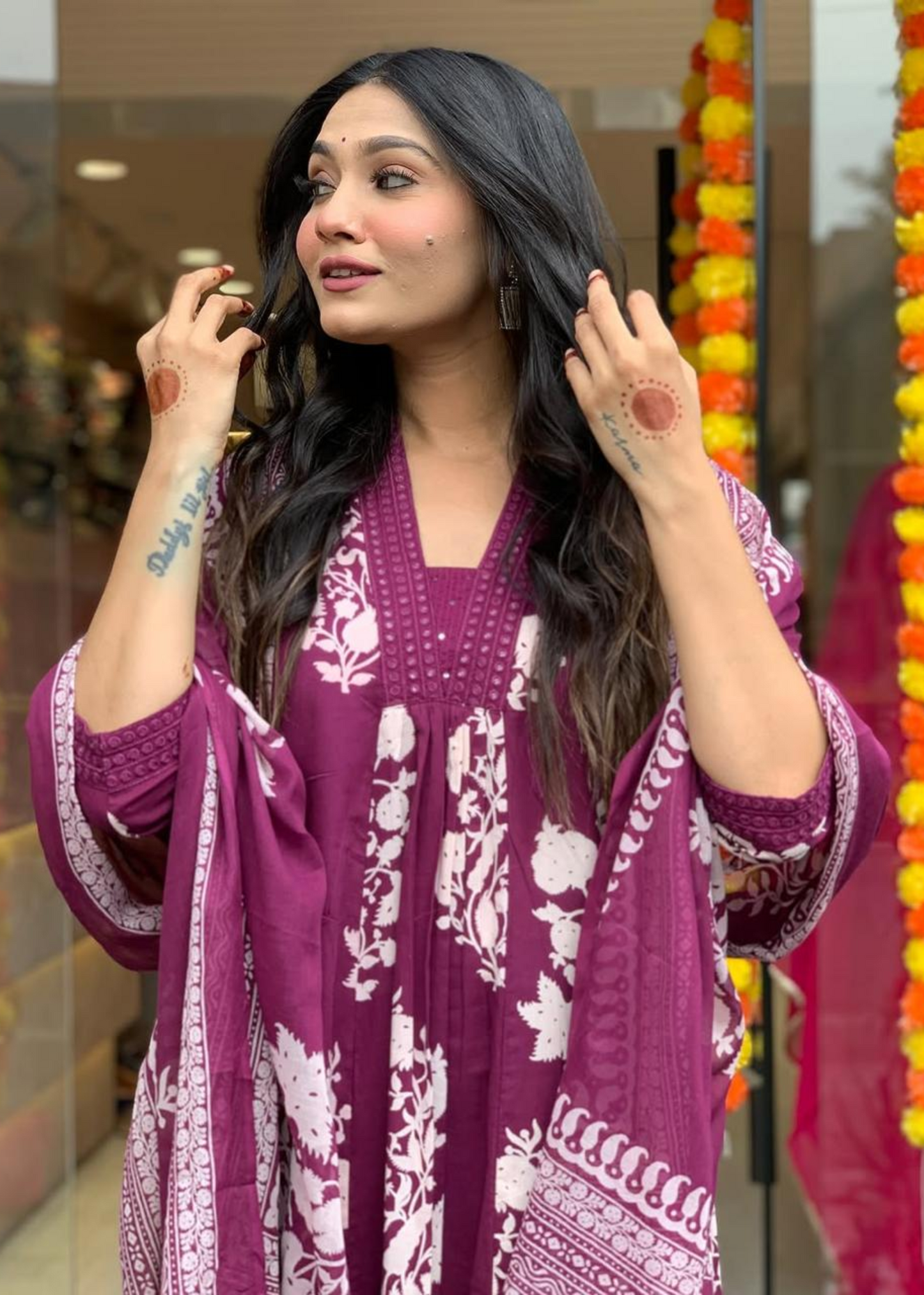 Stylish pleated V-neck A-line kurta set in magenta and white, featuring a graceful floral print with coordinated palazzos and dupatta.
