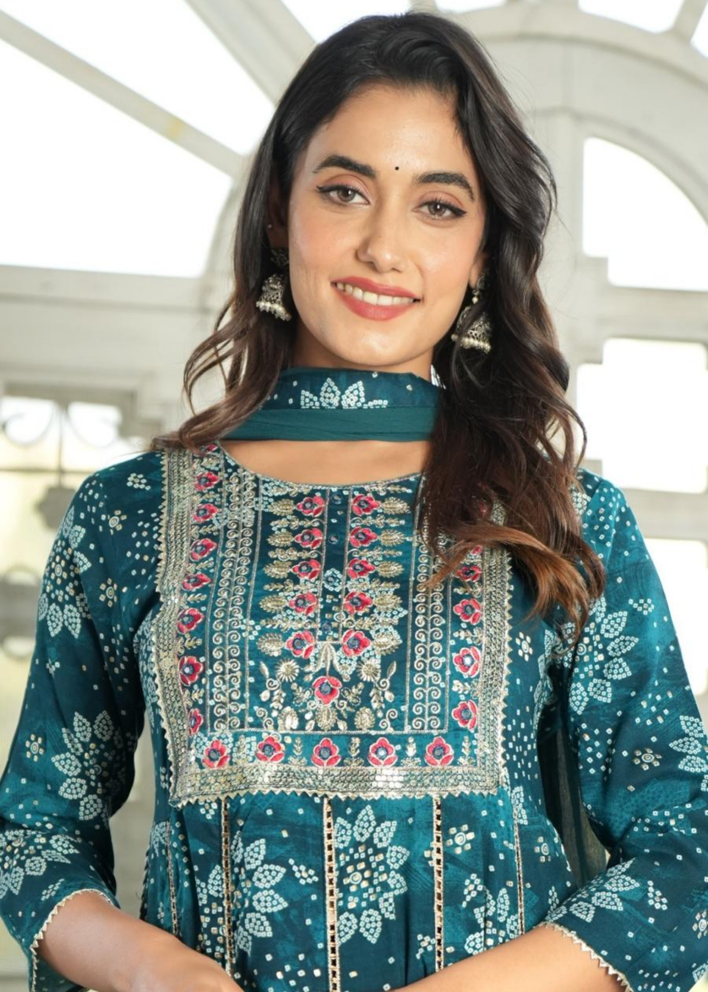 Classic Bandhni print Anarkali kurti set with a flattering silhouette, matching pants, and a dupatta for a festive touch.
