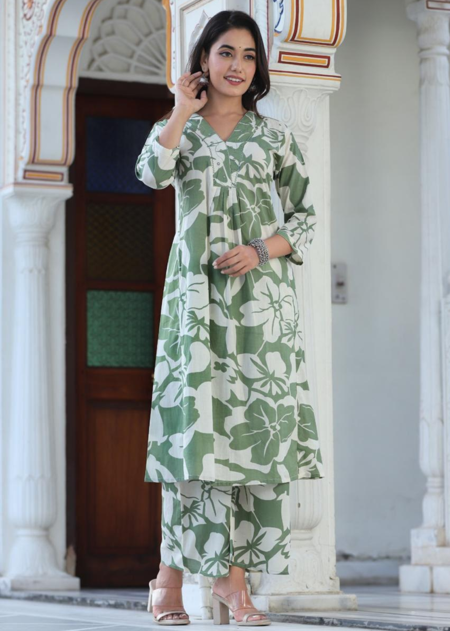 Chic and breezy floral printed kurta set in green, featuring a classic design with coordinated palazzos.
