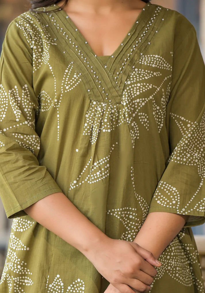 Stylish mehendi green kurta set featuring abstract floral prints and delicate bead embellishments for a touch of glamour.