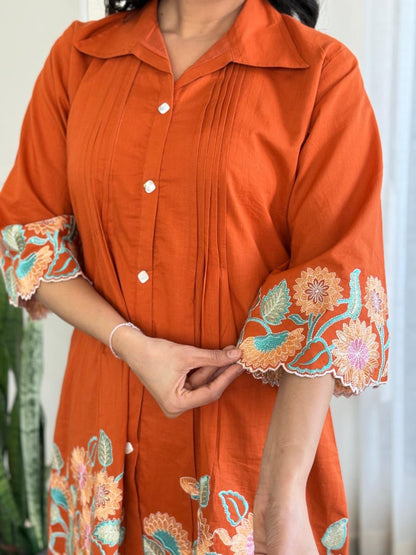 Stylish orange cotton co-ord set with beautiful embroidery and sequin work, blending elegance with modern fashion.
